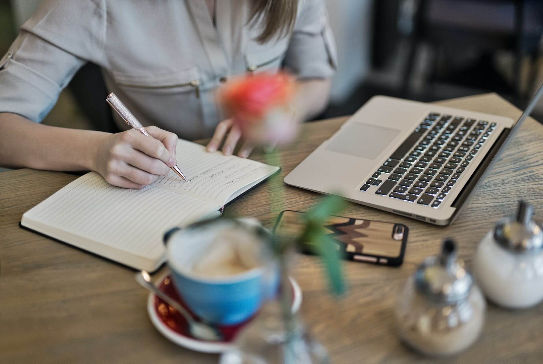 Woman Writing Notebook learning more about CIPD qualifications